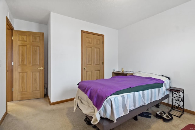 bedroom featuring carpet floors and baseboards