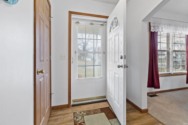 entrance foyer with baseboards and light wood-style floors