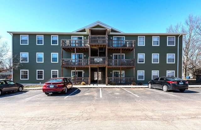 view of building exterior with uncovered parking