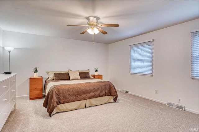 bedroom featuring light carpet, visible vents, and baseboards