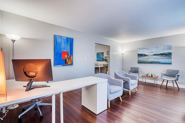 home office with dark wood-type flooring and baseboards