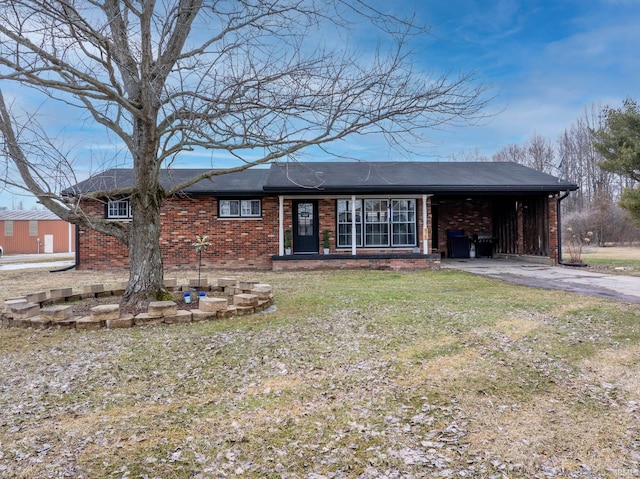 ranch-style house featuring aphalt driveway, a front yard, and brick siding