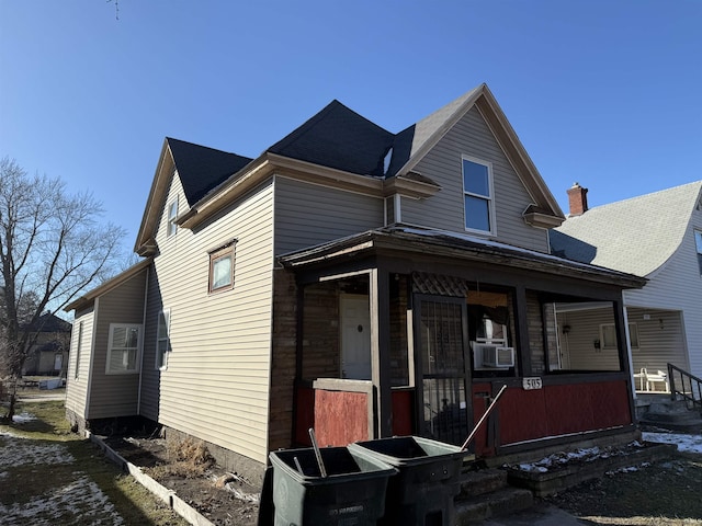 view of front of house with a porch and cooling unit