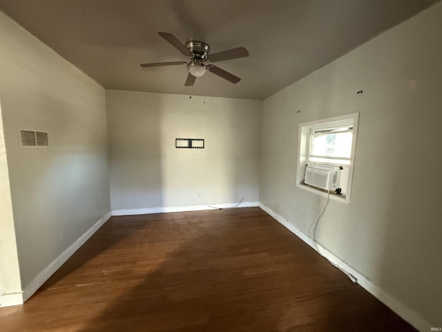 empty room with a ceiling fan, wood finished floors, visible vents, and baseboards