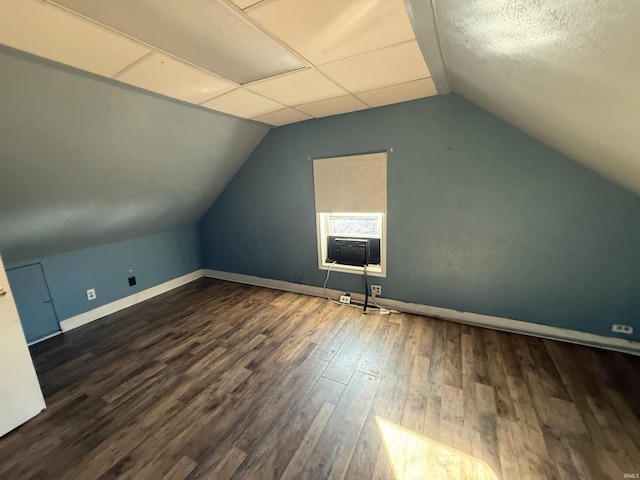 bonus room with lofted ceiling, baseboards, cooling unit, and wood finished floors