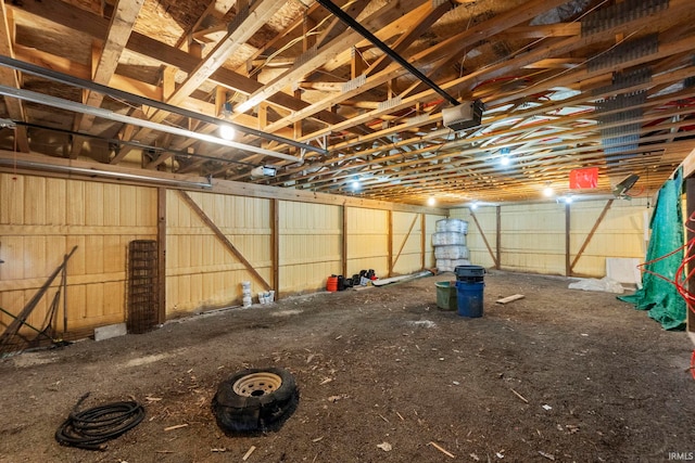 garage with a garage door opener and metal wall