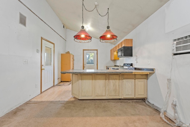 kitchen featuring black microwave, light carpet, a peninsula, an AC wall unit, and range