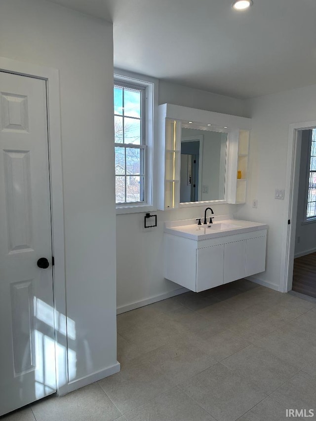 bathroom featuring recessed lighting, vanity, and baseboards