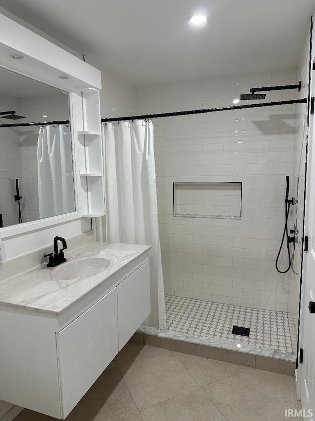 bathroom featuring a stall shower, tile patterned flooring, and vanity