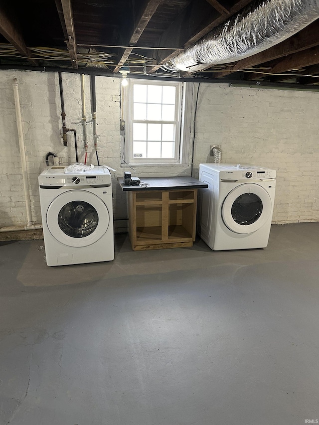 clothes washing area with washing machine and dryer and laundry area