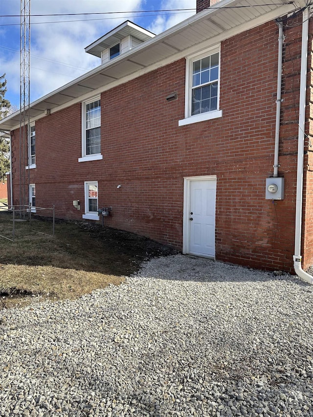 view of side of home with brick siding