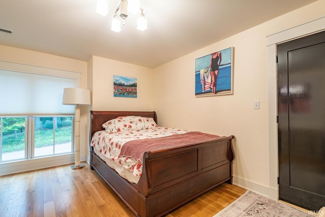 bedroom featuring baseboards and wood finished floors