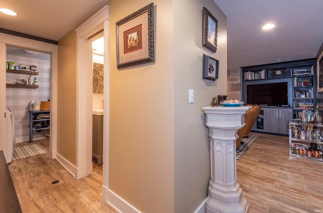 hall featuring baseboards, wood finished floors, and recessed lighting