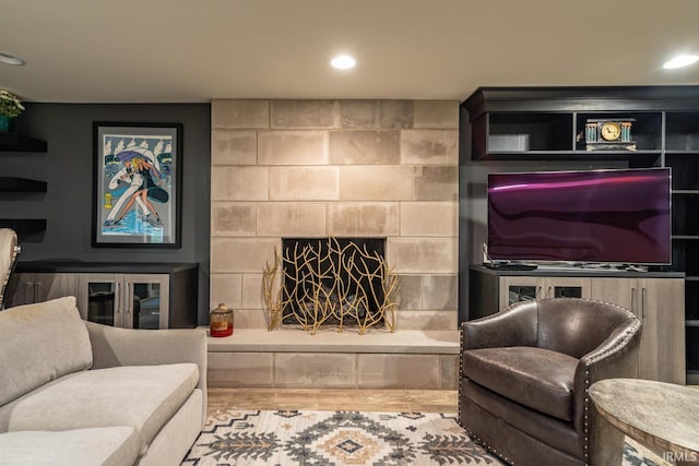 living room with a fireplace and recessed lighting