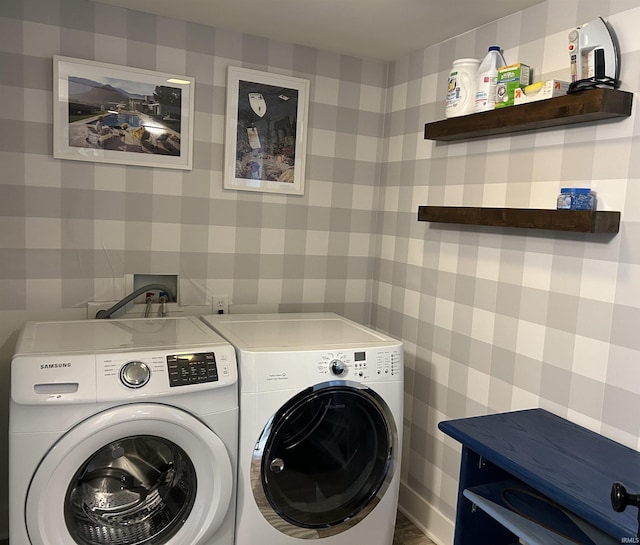 washroom featuring laundry area, washing machine and clothes dryer, and wallpapered walls