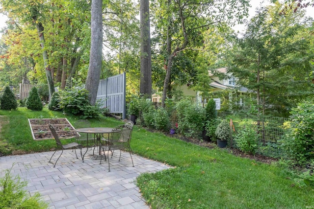 view of yard with a patio area, a garden, and fence