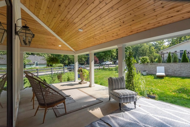 view of patio / terrace featuring fence and a porch