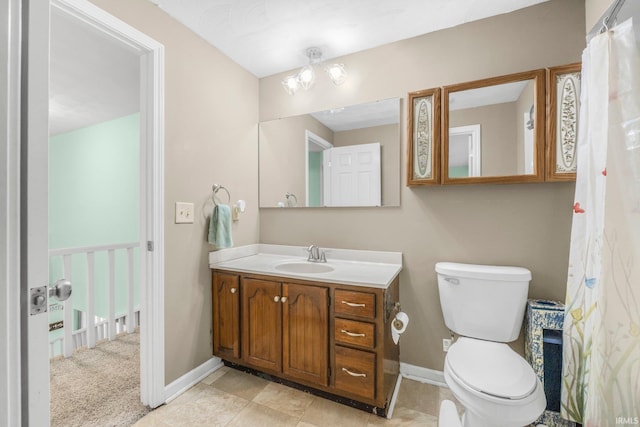 full bathroom featuring toilet, vanity, and baseboards