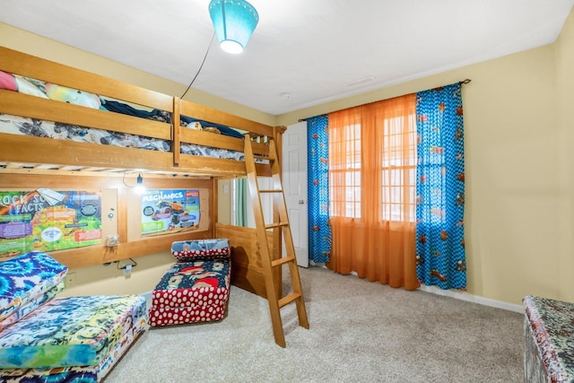 bedroom featuring carpet and baseboards