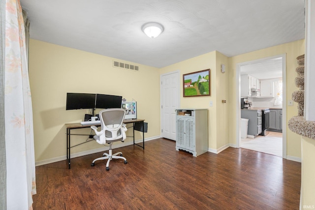 office with visible vents, baseboards, and wood finished floors