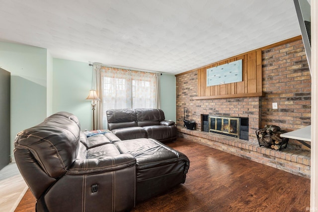 living room with light wood finished floors and a brick fireplace