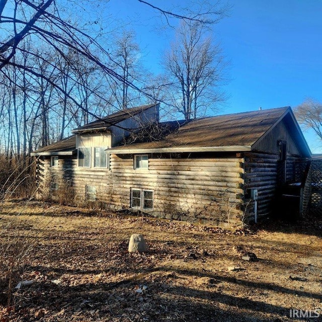 view of home's exterior with log siding