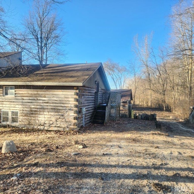 view of side of home featuring log siding