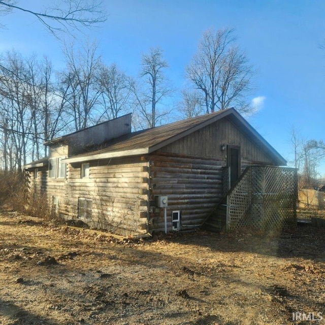 view of side of home featuring log exterior