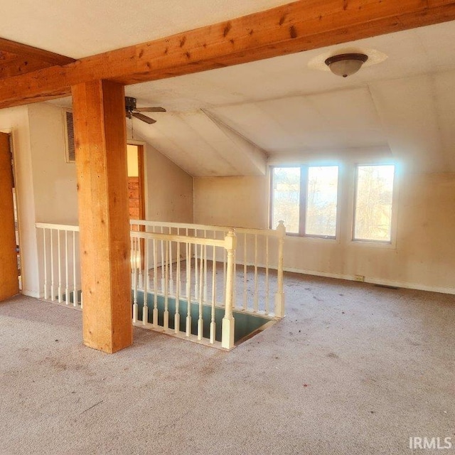 bonus room with lofted ceiling and carpet