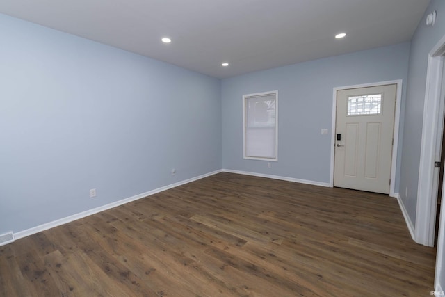 foyer entrance with dark wood-type flooring and recessed lighting