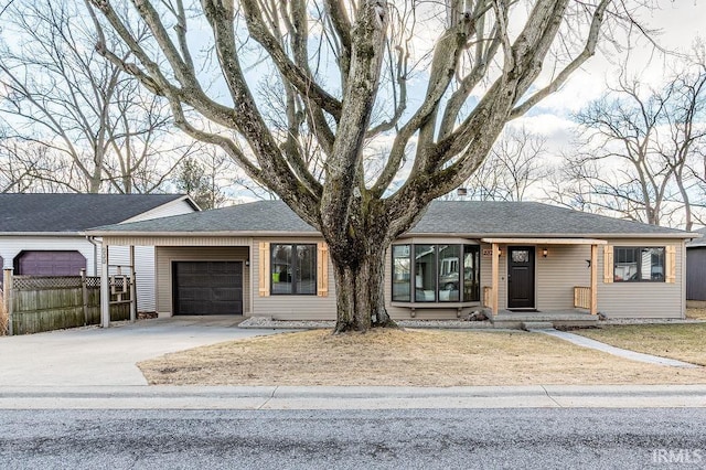 single story home featuring a garage, driveway, a shingled roof, and fence