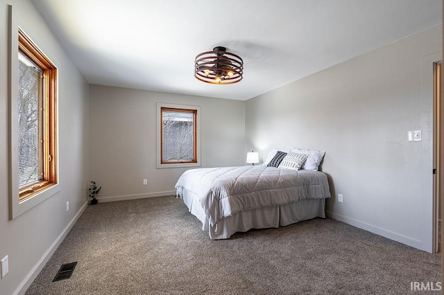 bedroom with baseboards, visible vents, and carpet flooring