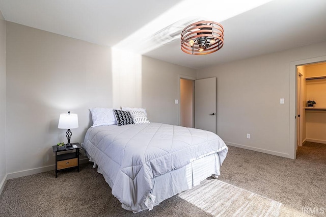 carpeted bedroom featuring baseboards