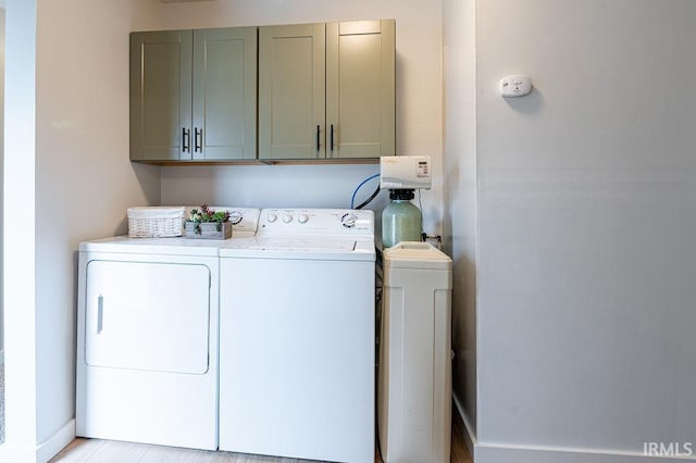 laundry area with washer and clothes dryer and cabinet space