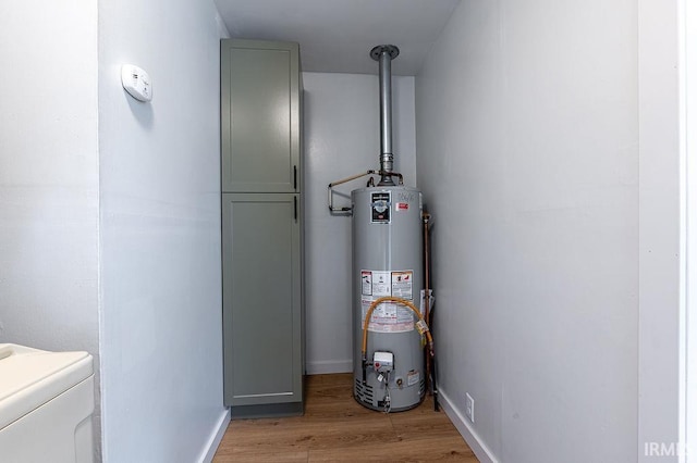 utility room featuring washer / dryer and water heater