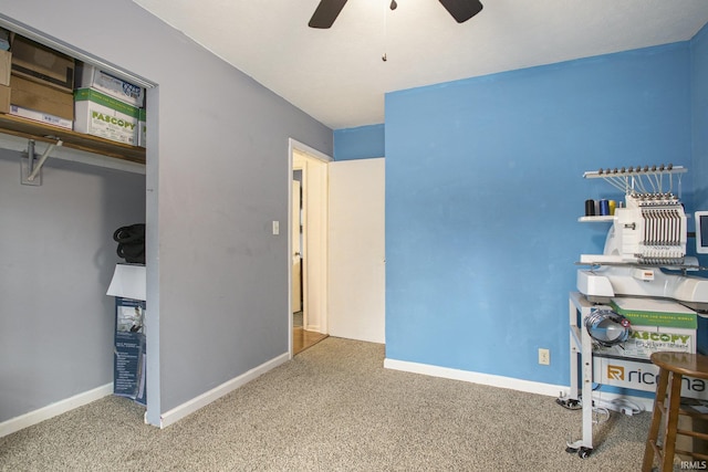 office area with ceiling fan, baseboards, and carpet flooring