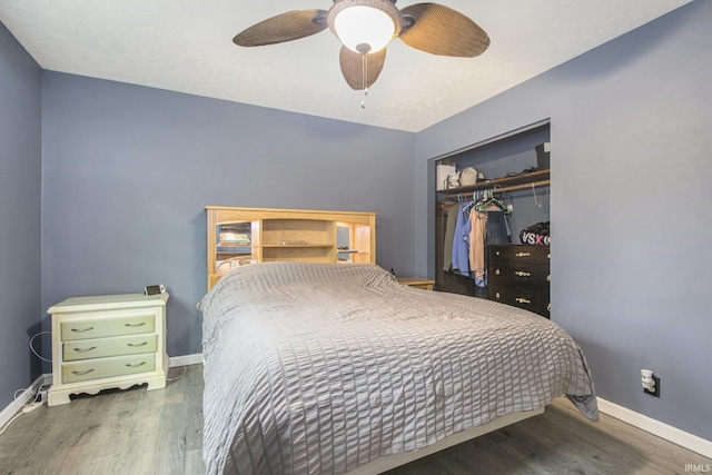 bedroom featuring a closet, baseboards, and wood finished floors