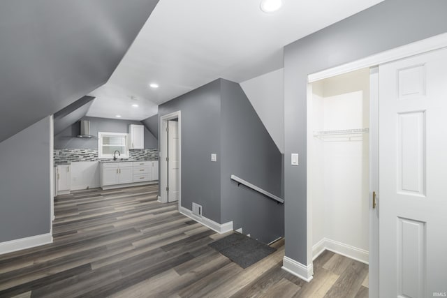 additional living space featuring lofted ceiling, recessed lighting, dark wood-style flooring, visible vents, and baseboards