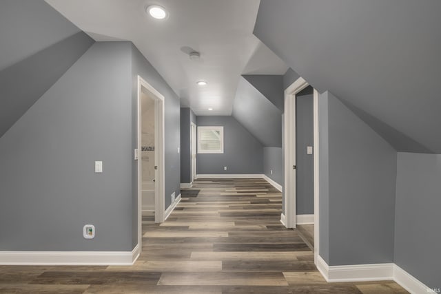 additional living space featuring lofted ceiling, recessed lighting, wood finished floors, and baseboards