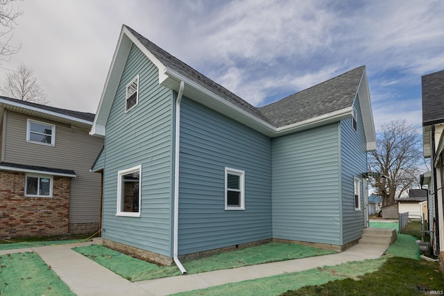 exterior space with a shingled roof