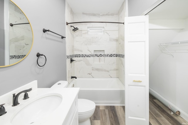 bathroom featuring bathtub / shower combination, toilet, vanity, wood finished floors, and baseboards