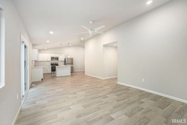 unfurnished living room featuring ceiling fan, recessed lighting, baseboards, vaulted ceiling, and light wood finished floors