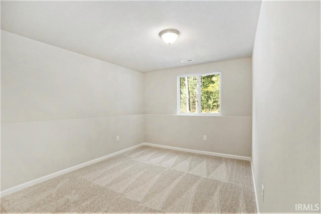empty room featuring carpet flooring and baseboards