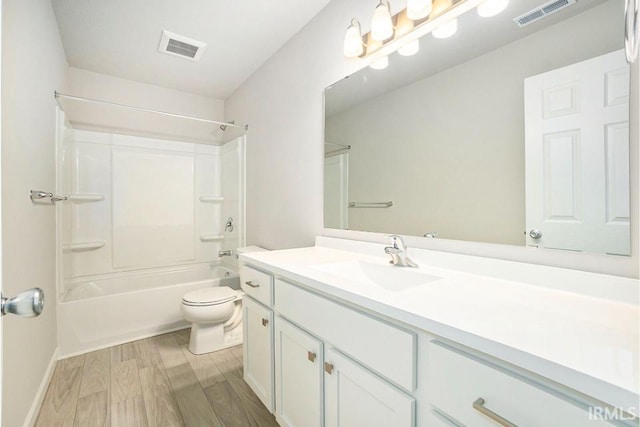 full bath featuring toilet, visible vents, wood finished floors, and vanity
