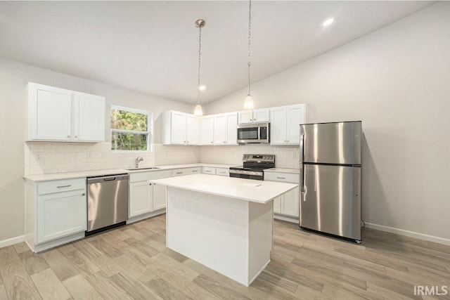 kitchen featuring a sink, light countertops, appliances with stainless steel finishes, light wood-type flooring, and a center island