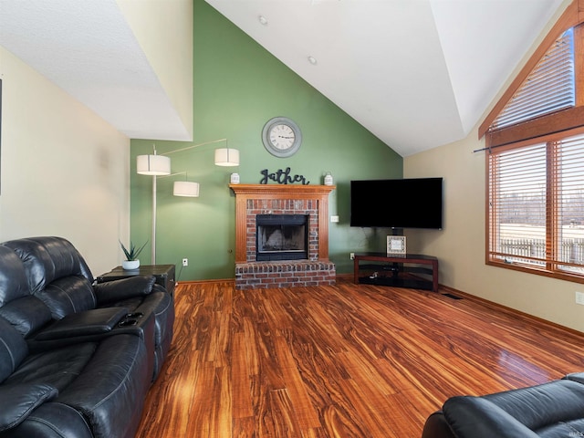 living area with high vaulted ceiling, a fireplace, wood finished floors, and visible vents