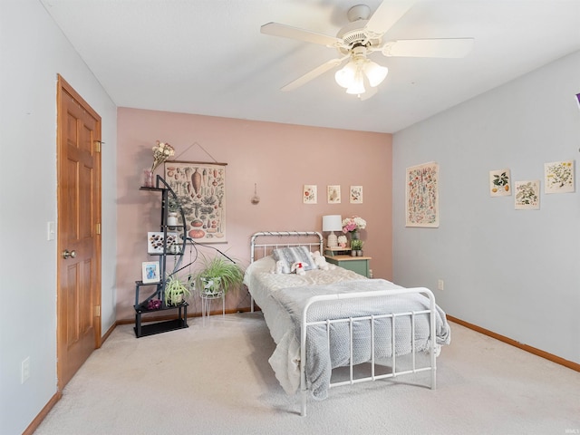 carpeted bedroom featuring a ceiling fan and baseboards