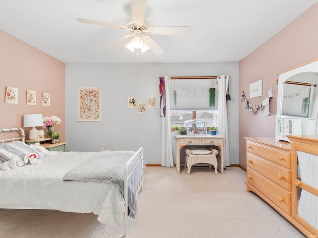 bedroom featuring light carpet, ceiling fan, and baseboards