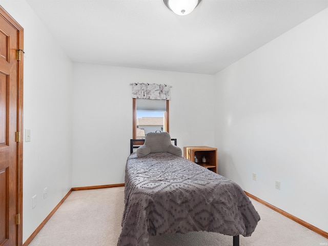 carpeted bedroom featuring baseboards