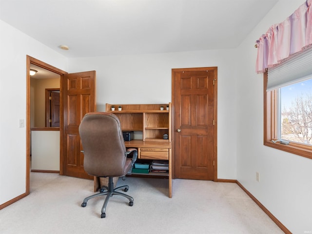 carpeted office space with baseboards